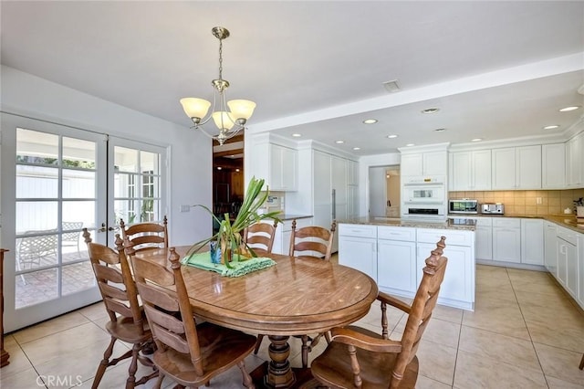 dining room with a chandelier, light tile patterned floors, and recessed lighting