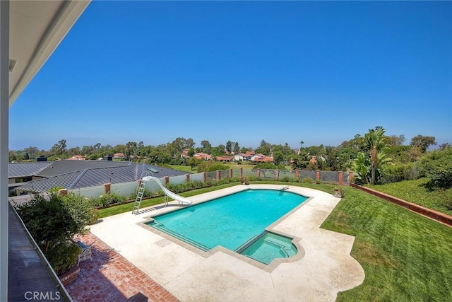 view of swimming pool featuring a yard, a water slide, a patio, and a fenced backyard