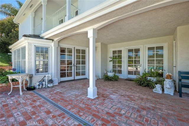 view of patio / terrace featuring french doors and a balcony