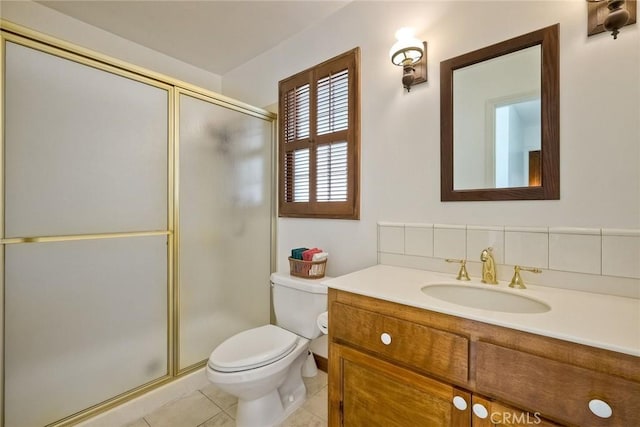 bathroom with tile patterned flooring, a shower stall, toilet, and vanity