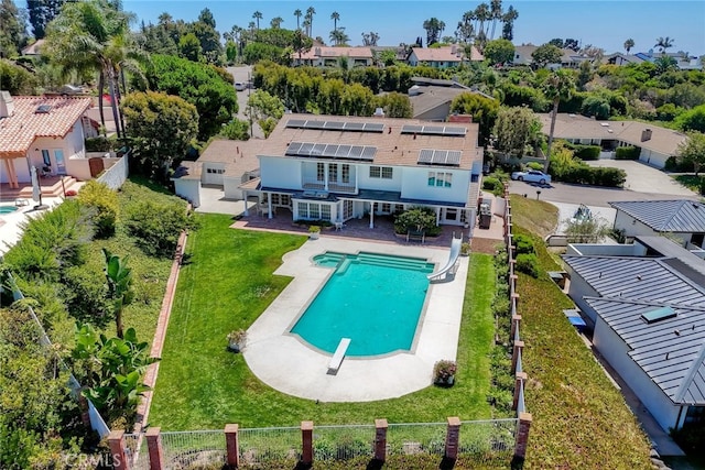 exterior space with a patio, a water slide, a diving board, and a lawn