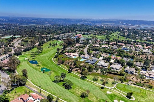 drone / aerial view featuring view of golf course and a residential view