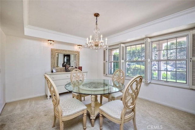 dining area featuring light carpet, baseboards, a wealth of natural light, and crown molding