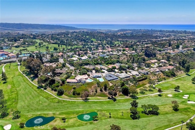 drone / aerial view with a water view and golf course view