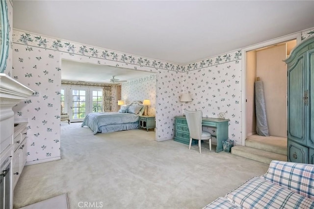 bedroom featuring light carpet, french doors, and wallpapered walls