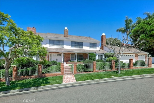 view of front of home with a fenced front yard and stucco siding