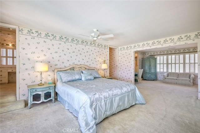 bedroom featuring wallpapered walls, a ceiling fan, and carpet flooring