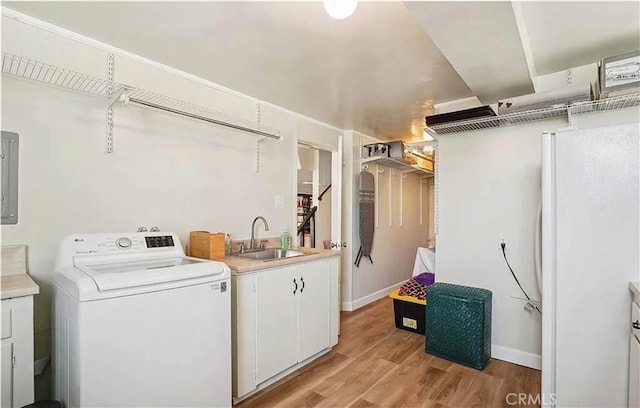 laundry room with washer / clothes dryer, cabinets, sink, light wood-type flooring, and electric panel