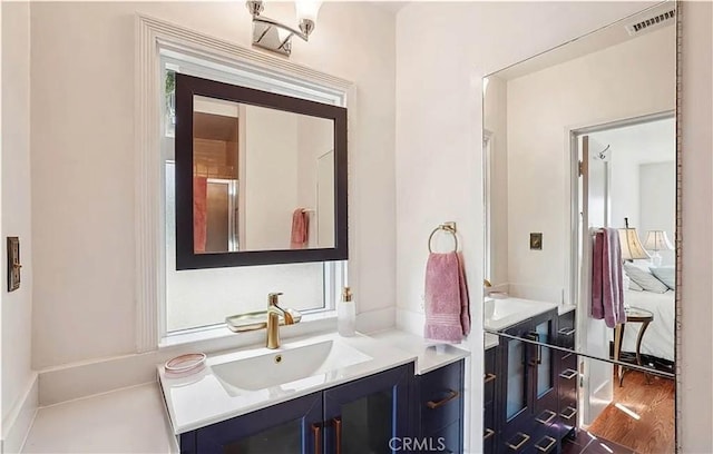 bathroom featuring hardwood / wood-style flooring and vanity