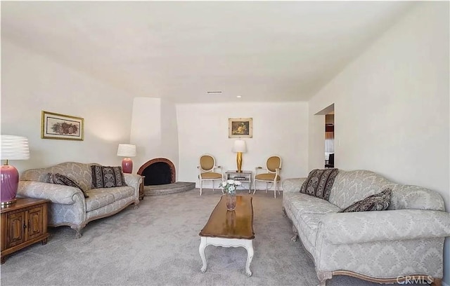 carpeted living room with a fireplace