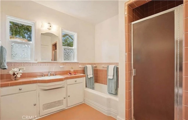 bathroom with a healthy amount of sunlight, backsplash, and vanity