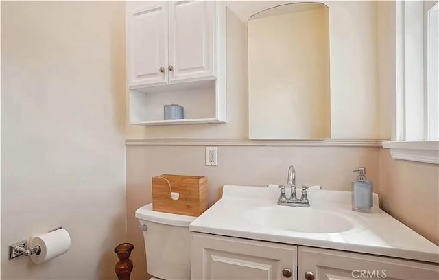 bathroom with toilet and vanity