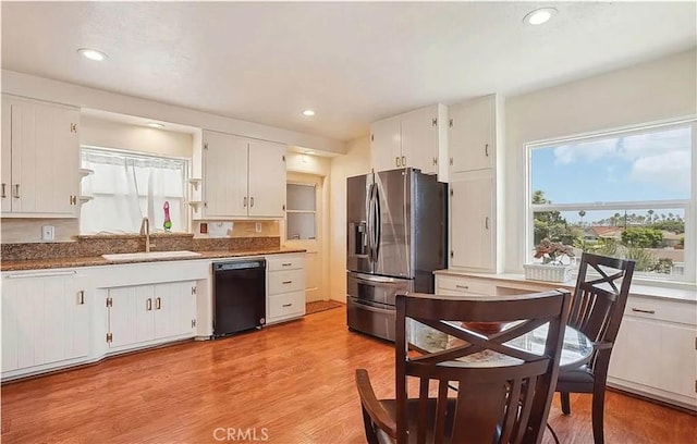 kitchen with sink, white cabinets, stainless steel fridge, and dishwasher