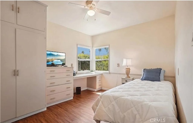 bedroom with ceiling fan and hardwood / wood-style flooring