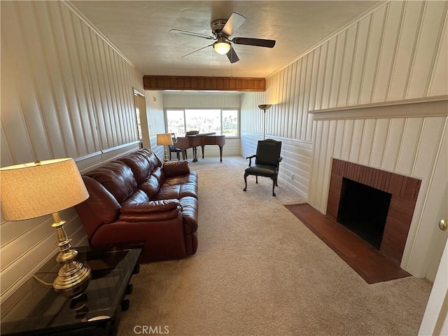 carpeted living room featuring ceiling fan and a fireplace