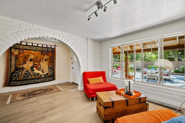 sitting room featuring track lighting and hardwood / wood-style floors