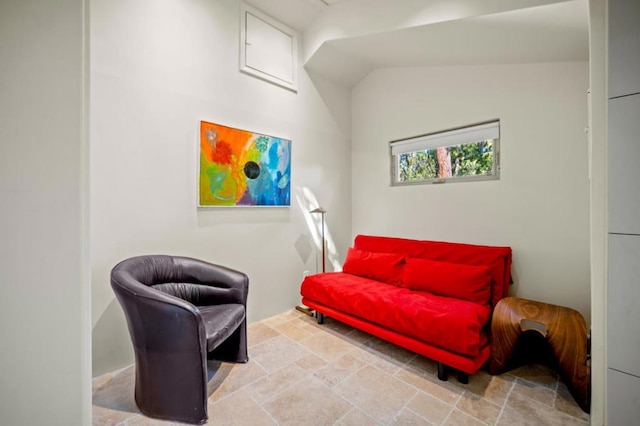 sitting room featuring vaulted ceiling