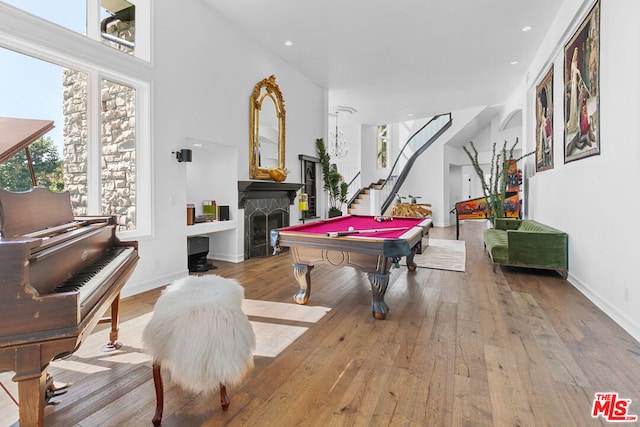 rec room featuring billiards, light wood-type flooring, and a wealth of natural light