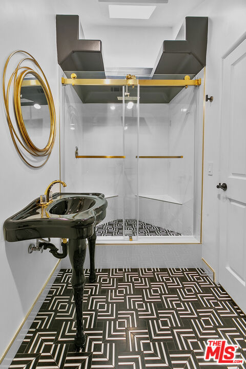 bathroom featuring a shower with shower door