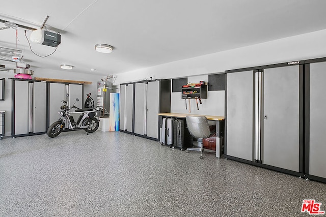 garage with gas water heater and a garage door opener