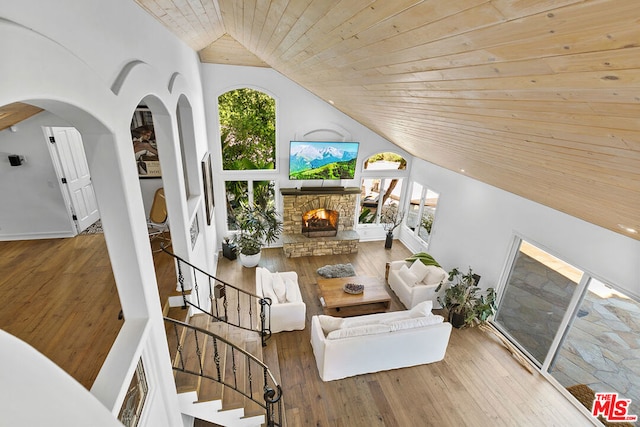 living room with hardwood / wood-style flooring, wood ceiling, a fireplace, and a wealth of natural light