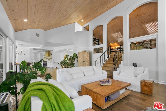 living room featuring lofted ceiling, wood-type flooring, and wooden ceiling