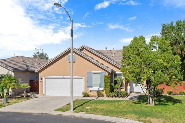 view of front of home with a front yard and a garage