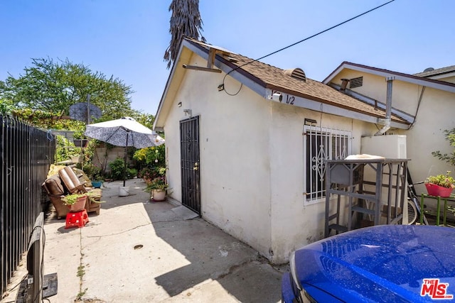 view of side of property with a patio