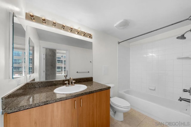 full bathroom with a healthy amount of sunlight, tiled shower / bath combo, vanity, and toilet