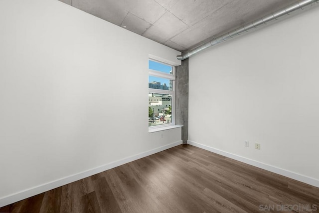 empty room with hardwood / wood-style floors