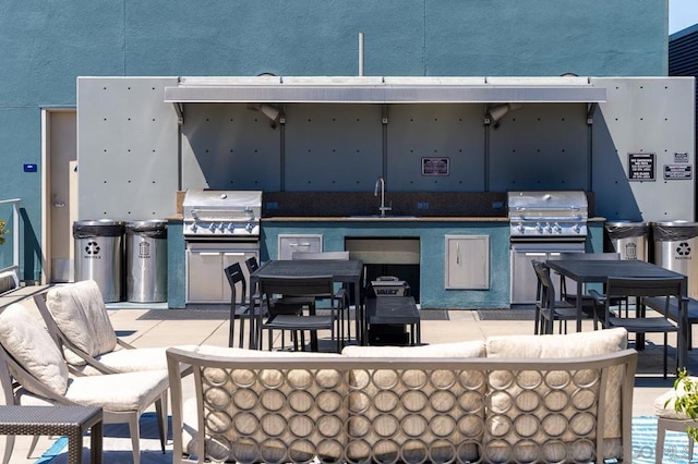 view of patio / terrace with an outdoor living space, area for grilling, and sink