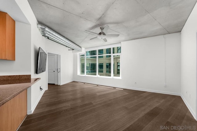 interior space with ceiling fan and dark hardwood / wood-style flooring