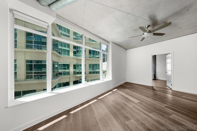 empty room featuring ceiling fan and hardwood / wood-style floors