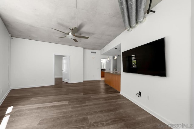 unfurnished living room with ceiling fan, dark hardwood / wood-style floors, and sink