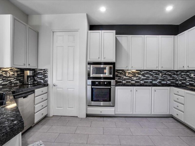 kitchen featuring decorative backsplash, white cabinetry, and appliances with stainless steel finishes