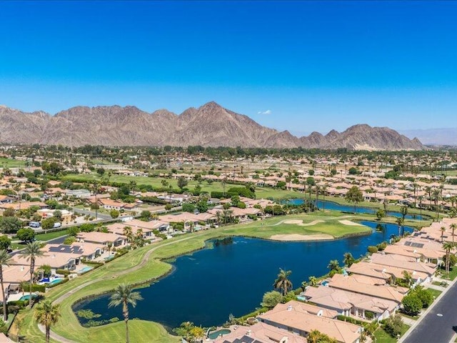 birds eye view of property with a water and mountain view