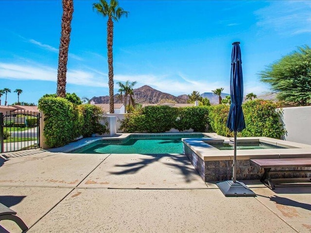 view of pool featuring an in ground hot tub and a mountain view