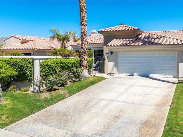 mediterranean / spanish-style home with a garage