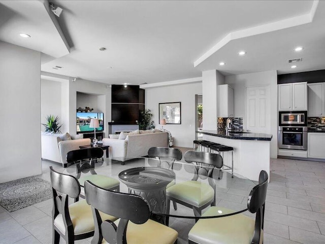 dining area with built in features and sink