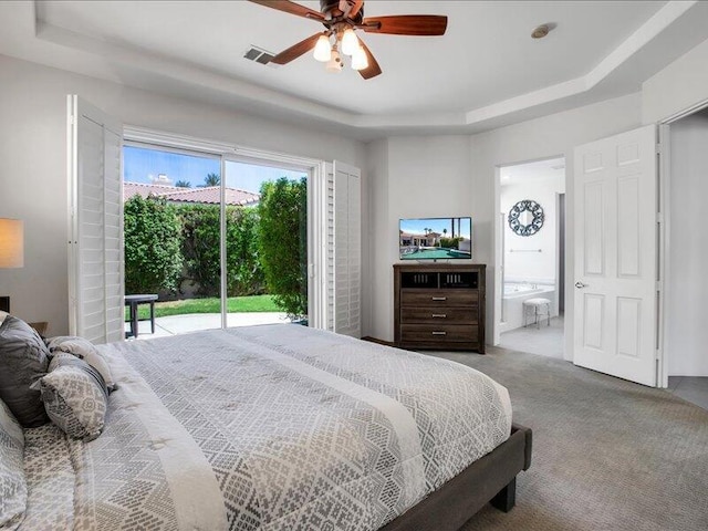 bedroom with access to exterior, ensuite bath, a raised ceiling, ceiling fan, and carpet floors