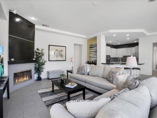 living room with light tile patterned floors and sink