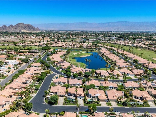 drone / aerial view featuring a water and mountain view