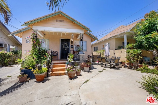 bungalow-style house featuring a patio area