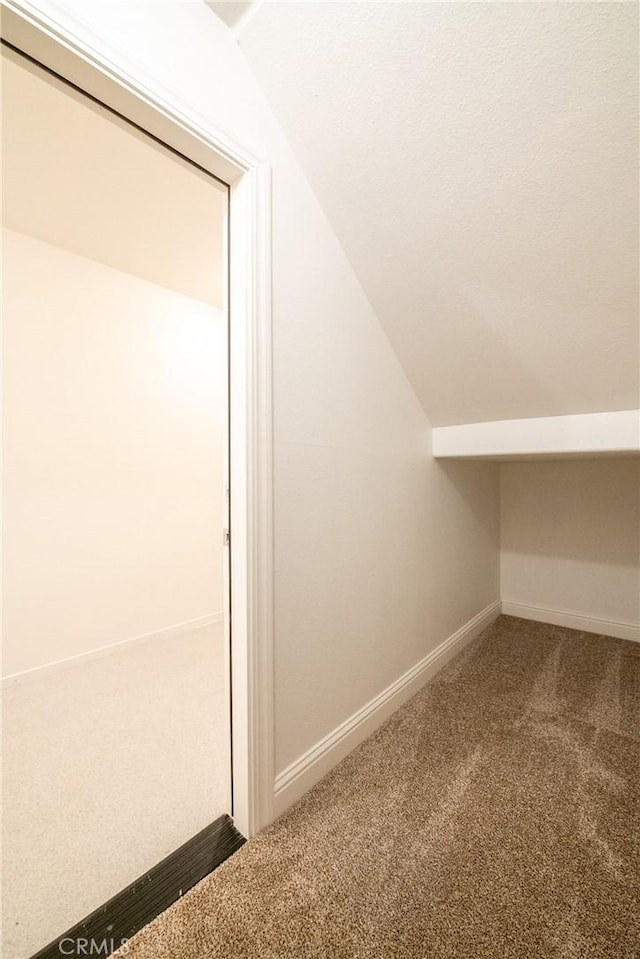 interior space with carpet and lofted ceiling