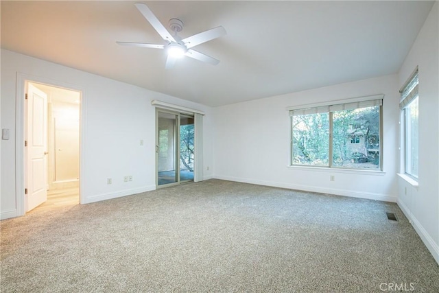 carpeted empty room featuring ceiling fan