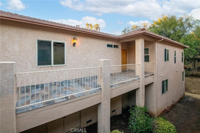 rear view of property featuring a balcony