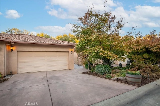 10 Hidden Brooke Way, Chico, CA 95928 - view of front of house featuring stucco siding, concrete driveway, a tiled roof, and a garage