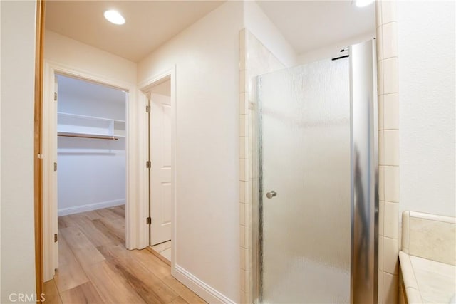 bathroom featuring walk in shower and hardwood / wood-style flooring