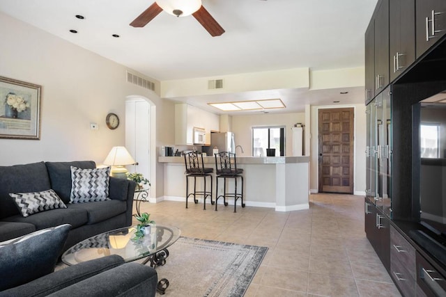 living room with ceiling fan and light tile patterned flooring