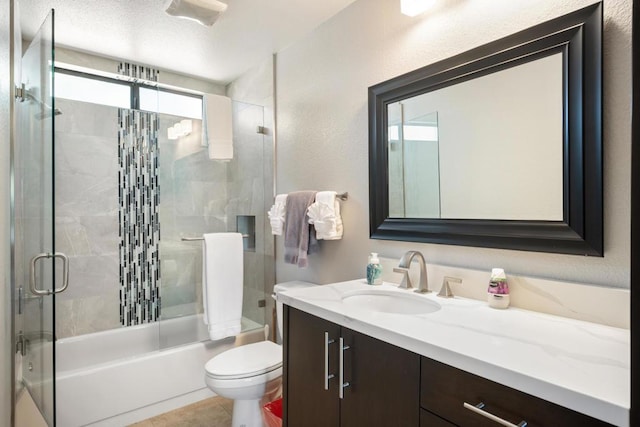 full bathroom featuring tile patterned flooring, vanity, enclosed tub / shower combo, and toilet